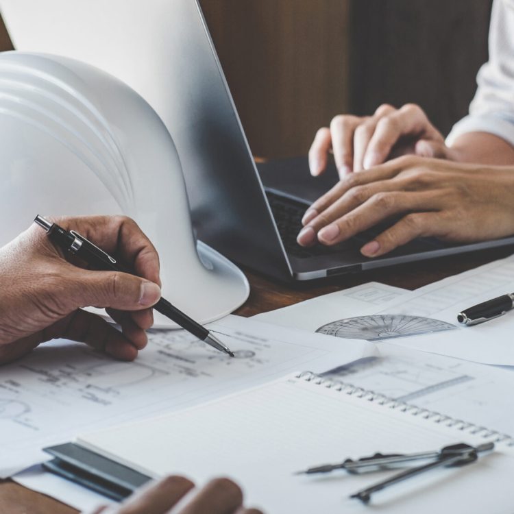 Construction and structure concept of engineer working drawing on blueprint meeting for project working with partner on model building and engineering tools in working site, construction concept.
